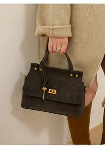 Close-up of the vintage grey handbag featuring a gold square lock and a key-shaped charm