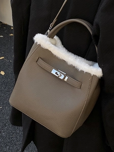 Chic winter bucket bag in elephant grey with plush fur trim and metal swivel lock detail