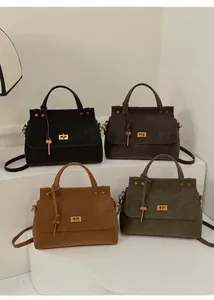 Multiple colors of vintage crossbody bags in black, grey, tan and olive green on display
