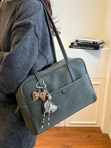 Deep olive green vintage tote bag with contrast stitching and decorative bow charm