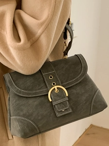 Retro grey-green shoulder bag with cracked leather texture and horseshoe gold buckle