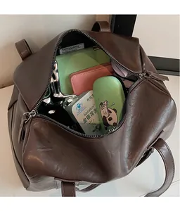 Top view of spacious interior of dark brown leather tote bag with zip closure