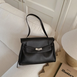 Detail of black pebbled leather tote bag with silver metallic twist lock closure