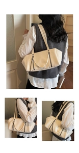 Detail view of stylish cream white trapezoidal shoulder bag with metal chain accents