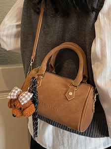 Retro brown leather Boston handbag with a cute teddy charm and adjustable shoulder strap