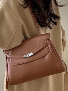 Retro brown leather tote bag with silver twist-lock closure in a minimalist trapezoid design