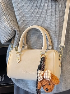 Beige Boston handbag with crossbody strap and cute teddy bear charm for women