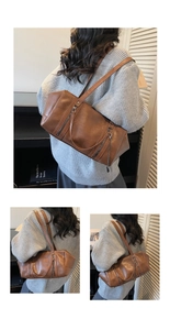 Detail view of vintage brown leather handbag with silver chain and textured finish