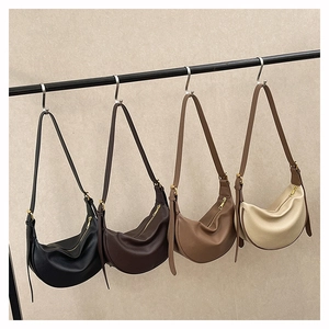 Detail view of crescent crossbody bags in four colors with pebbled leather and gold zippers