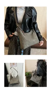 Detail of grey vintage suede tote bag with retro charm and large capacity for women