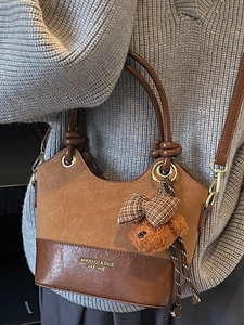 Retro brown contrast stitching handbag with plush bear charm and adjustable strap