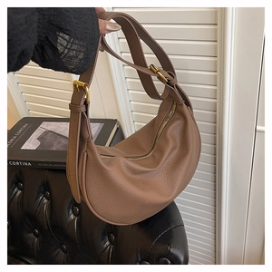 Close-up of dark brown hobo bag featuring litchi grain texture and gold metal zipper detail