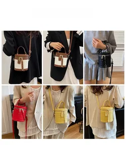 Mini cylinder bucket bags in four colors shown with model for crossbody and hand carry use