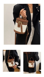 Detailed macro view of retro bucket bag with floral embossing and gold hardware finish