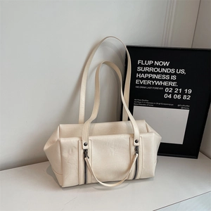 Detailed view of cream white leather shoulder bag with vertical decorative zippers