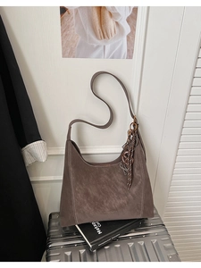 Detail view of deep brown matte Hobo bag with woven knot and metal ring hardware