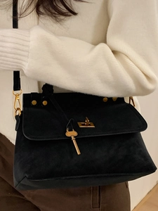 Vintage black suede crossbody bag for women with elegant golden hardware and key pendant