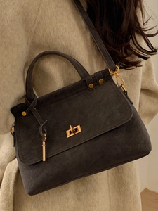 Classic dark grey suede handbag with gold turn-lock closure and adjustable strap