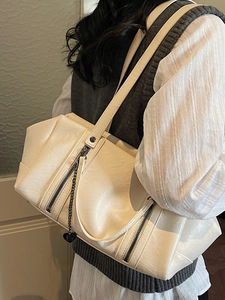 Chic beige faux leather shoulder bag with zipper decor and heart charm for women