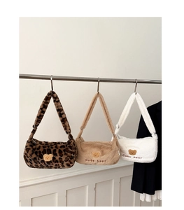 Vue détaillée de sacs à bandoulière en peluche léopard, beige et blanc avec patchs ours
