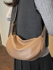 Brown lychee leather crescent bag for women with an adjustable wide shoulder strap