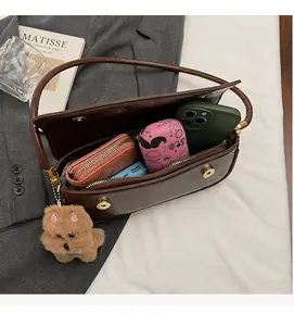 Brown retro baguette bag interior showing spacious storage for wallet and smartphone