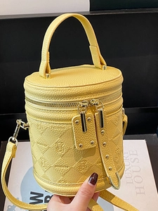 Chic yellow quilted bucket bag with bear motif and top handle for trendy women