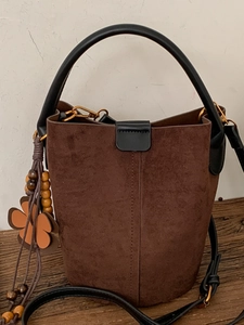 Retro brown suede bucket bag with clover wood bead charm and black leather handle straps