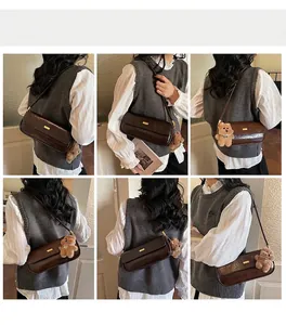 Brown vintage baguette bag with gold buckle and bear charm shown in multiple angles