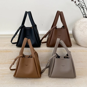 Detail view of four vintage bucket bags in litchi grain leather with multi-color options