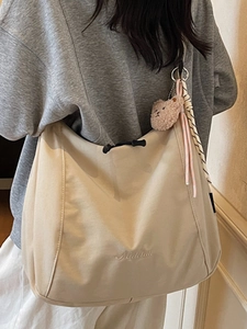Large cream canvas tote bag with drawstring closure and teddy bear charm for women