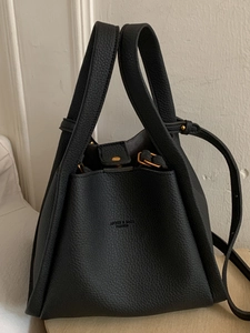 Classic black litchi leather bucket bag with top handles and adjustable shoulder strap