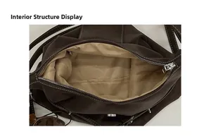 Structure interne du cabas en cuir marron montrant la doublure beige et le zip argenté