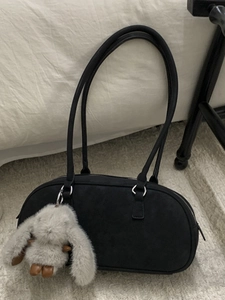 Minimalist black oval underarm bag with double tube straps and a cute grey bunny charm