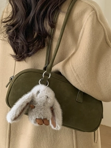Chic olive green suede underarm bag for women with a cute plush rabbit pendant charm