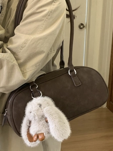 Brown suede underarm bag with cute bunny pendant for women stylish winter fashion look