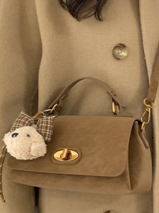 Chic khaki flap handbag for women with plush puppy charm and golden twist lock