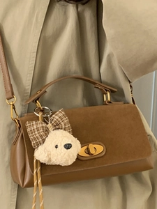 Brown patchwork crossbody handbag for women with plush charm and golden swivel lock