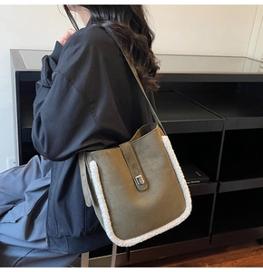 Detail of olive green suede bucket bag with white faux fur trim and silver turn-lock