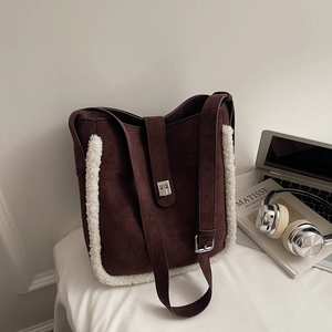 Detail showing brown faux suede and white shearling trim of the winter bucket bag