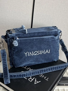Classic dark blue denim crossbody bag with triple zippers and white embroidery