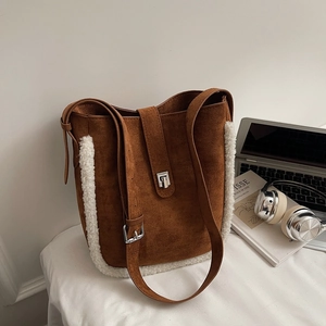 Brown suede bucket bag with white fleece trim and silver metal buckle closure