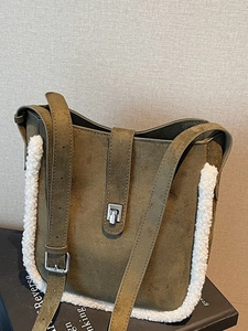 Retro green suede bucket bag with white shearling trim and adjustable strap for winter