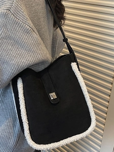 Winter minimalist black bucket bag with white faux fur trim and silver metal buckle closure