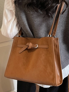 Brown vintage faux suede tote bag with decorative metal buckle and spacious shoulder strap