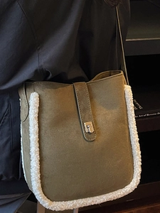 Brown suede bucket bag with white faux fur trim and silver buckle in a winter style