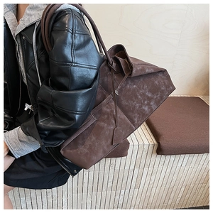 Close-up of large retro brown suede tote bag showing texture and oversized design