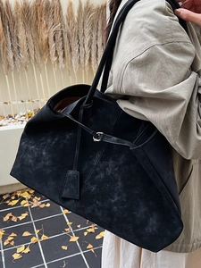 Large vintage black suede tote bag with drawstring detail, perfect for winter commuting
