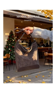 Deep brown winter hobo bag in a cozy outdoor scene with autumn leaves and warm lights