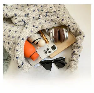 Spacious plush tote bag interior with water bottle, umbrella and daily essentials